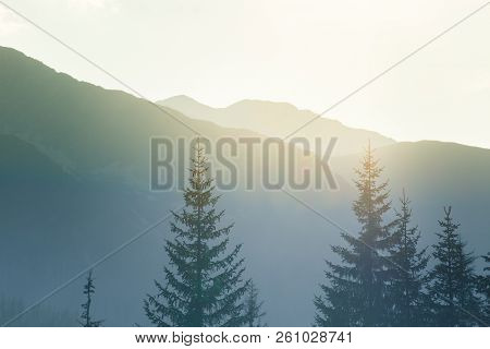 A Dreamy, Hazy Landscape Of A Mountains Close To Sunset. Sun Flase And Misty Look In Blue Tones. Mo