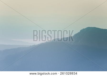 A Dreamy, Hazy Landscape Of A Mountains Close To Sunset. Sun Flase And Misty Look In Blue Tones. Mo