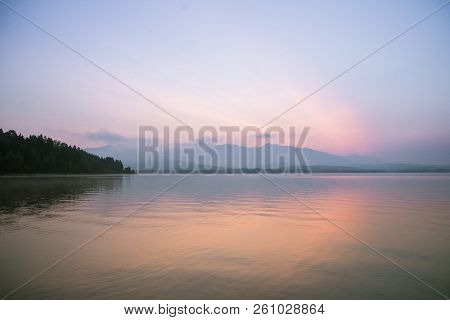 A Dreamy, Hazy Landscape Of A Mountains Close To Sunset. Sun Flase And Misty Look In Blue Tones. Mo