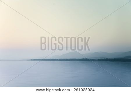 A Dreamy, Hazy Landscape Of A Mountains Close To Sunset. Sun Flase And Misty Look In Blue Tones. Mo