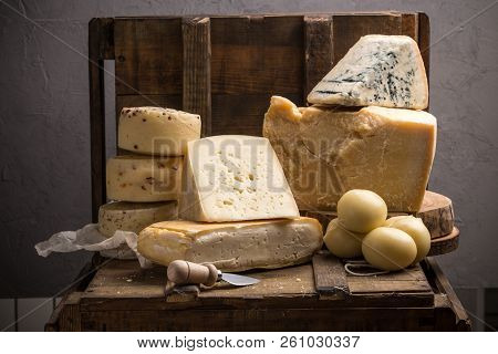 Parmesan, Taleggio, Caciotta And Asolo Cheese On Dark Wooden Table