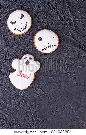Halloween Gingerbread Cookies On Black Background. Top View On White Halloween Biscuits In A Shape O
