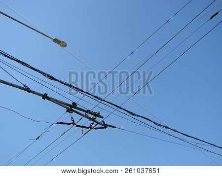Wires Pole With Blue Sky. Electrical Wires On A Background. Electric Cables. Power Cable With Blue S