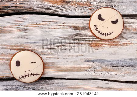 Jack Skellington Cookies On Vintage Background. Halloween Homemade Sugar Biscuits With Icing On Wood