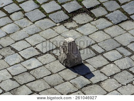 Typical Pavement Of The Streets Of Rome With Cobblestone (sanpietrini). In View Of One Of The Stone 