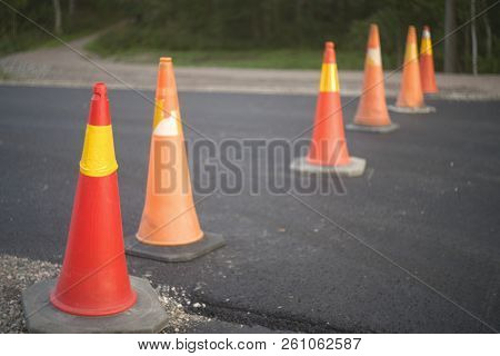 Road Cones Blocking Way On An Asphalth Street Beeing Buildt , Fall Off Focus