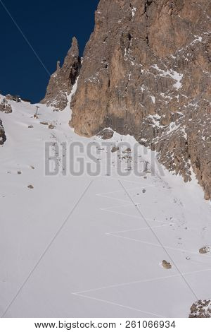 hiking touring ski tracks in snow climbing to mountain top at beautiful winter day with fresh snow