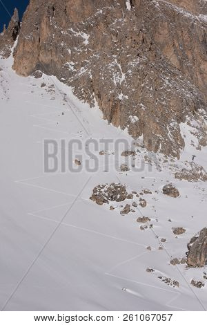 hiking touring ski tracks in snow climbing to mountain top at beautiful winter day with fresh snow