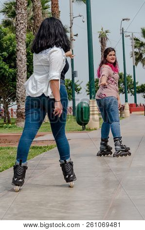 Two Chubby Girls With Inline Skates In The Park