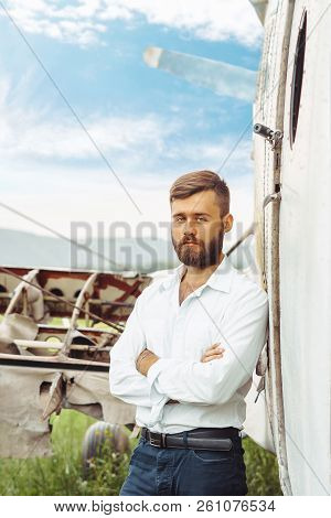 The Man In The Shirt Stands At The Old Plane