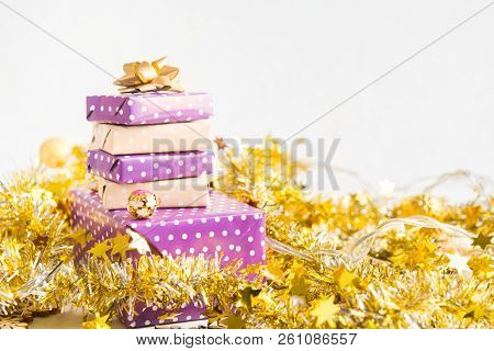 Beige And Violet (purple) Gift Boxes (presents) Stack With Ribbon With Golden Christmas Decoration