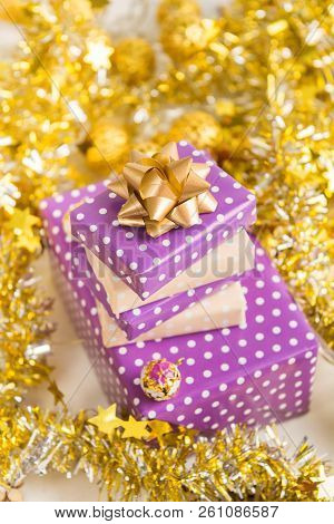 Beige And Violet (purple) Gift Boxes (presents) Stack With Ribbon With Golden Christmas Decoration