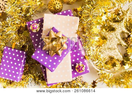 Beige And Violet (purple) Gift Boxes (presents) Stack With Ribbon With Golden Christmas Decoration