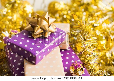 Beige And Violet (purple) Gift Boxes (presents) Stack With Ribbon With Golden Christmas Decoration