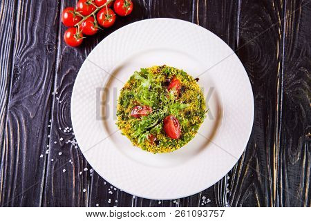 Salad From Bulgur And Fresh Vegetabes On White Plate In Restaurant