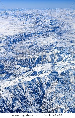 Aerial View On Snowy Mountain Chain Land From Airplane Over Afrcia.