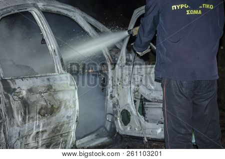 Firefighter Douses A Fire During, Fire Suppression On Car