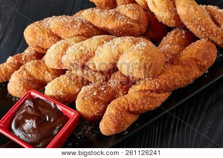 Twisted Korean Doughnuts - Kkwabaegi Sprinkled With Sugar And Served With With Chocolate Sauce On A 