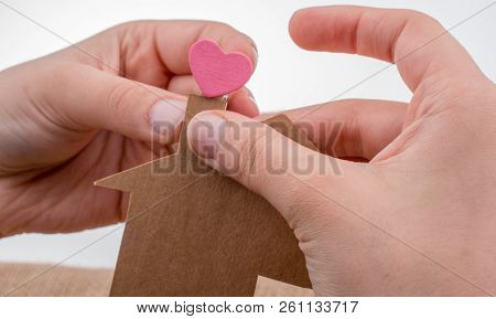 Hand Holding A Aper House On A Canvas Background