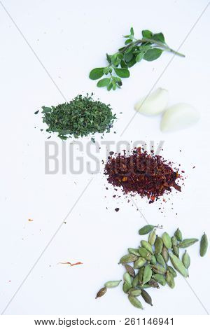 Dry Spices And Herbs In Glass Jar With A Cork, A Bowl Of Cherry Tomatoes And Chili Peppers, White Ba