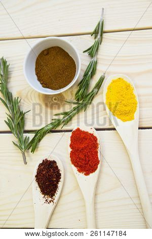 Cooking Hot Spicy Food Concept. Dry Spices, Beans And Herbs In Wooden Spoon And Plastic Cup On Light