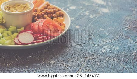 Rainbow Colored Vegetables, Chickpeas On The White Plae On The Blue Background, Toned Copy Space For