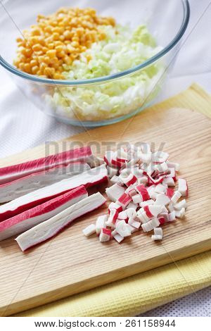 Surimi Sticks Cut On Wooden Cutting Board. Process Of Cooking Chinese Cabbage, Sweet Corn And Surimi