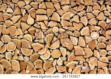 A Photo Of Dry Chopped Wood, Wooden Logs For A Fire Or A Fireplace Neatly Stacked In A Pile