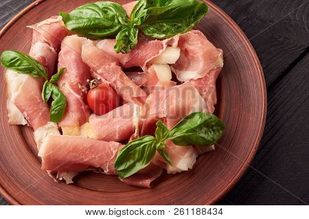 Small Pieces Of Pineapple Rolled In Jamon Iberico Or Proscuitto With Cherry Tomatoes And Spanac Leav