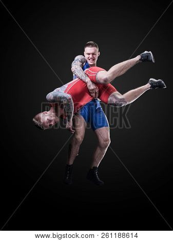 Two Wrestlers Figting Isolated On Black Back