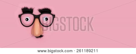 Funny Mask With Eyes And Nose On Pink Background As Panorama