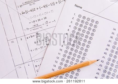 Pencil On Answer Sheets Or Standardized Test Form With Answers Bubbled. Multiple Choice Answer Sheet