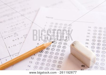 Pencil And Eraser On Answer Sheets Or Standardized Test Form With Answers Bubbled. Multiple Choice A