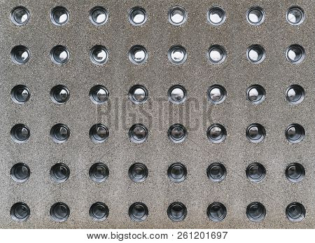 Modern Concrete Fence With Glass Insertions; A Grainy Texture Of Contemporary Stone Block With Round