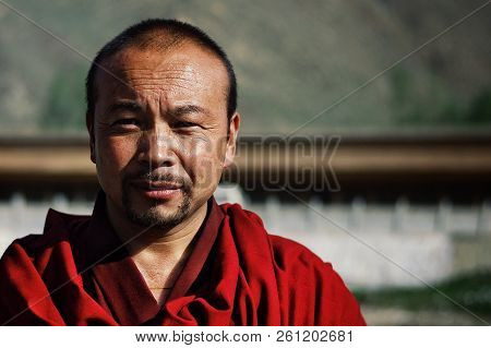 Labrang Monastery, Xiahe, Gansu Province / China - Jun 6 2011: Young Tibetan Buddhist Monk In A Red 