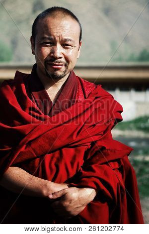 Labrang Monastery, Xiahe, Gansu Province / China - Jun 6 2011: Young Tibetan Buddhist Monk In A Red 