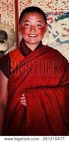 Labrang Monastery, Xiahe, Gansu Province / China - Jun 6 2011: Young Tibetan Buddhist Nun In Front O