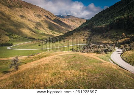 Perfect Winding Road Through The New Zealand Countryside, Near Queenstown, Otago