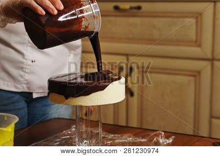 Cook Is Preparing A Mousse Cake Of Esterhazy. The Girl Pours Hazelnut Dacquoise With Glass Glaze. Ho