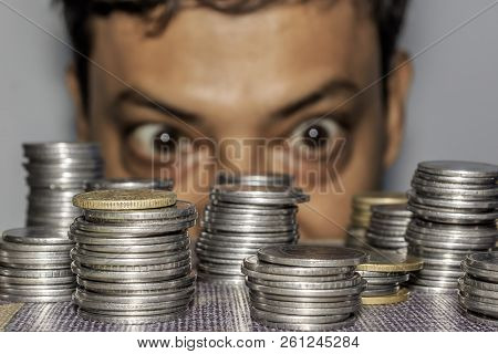 Focus On Coin. A Rich Greedy Elderly Man Looks At Coins. The Collector Looks At His Wealth. An Elder
