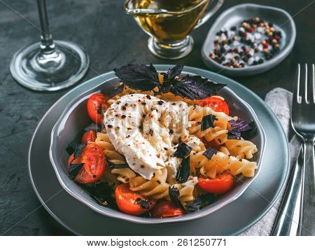 Tasty Italian Fusilli Pasta With Cherry, Mozarella Or Buratta Cheese And Fresh Basil. Dish With Past