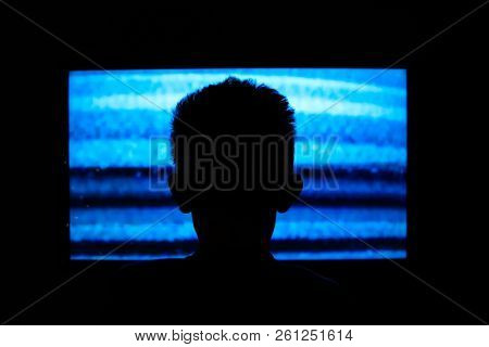 Boy watching television with noise