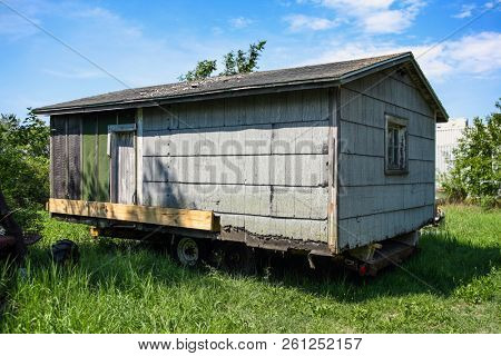 Old asbestos shingle houes on a trailer to be moved 