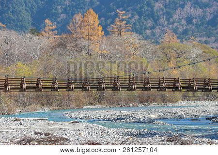 Myojin Bridge Among Natural River And Autumn Forest At Kamikochi Nagano Japan.
