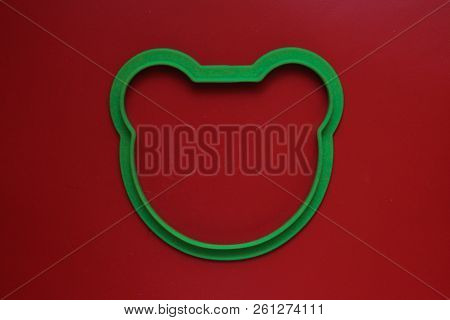 Silicone Shape In The Form Of A Bear's Head On A Red Background
