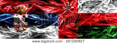 Serbia Vs Oman, Omani Smoke Flags Placed Side By Side. Thick Colored Silky Smoke Flags Of Serbian An