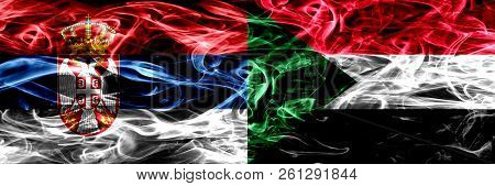 Serbia Vs Sudan, Sudanese Smoke Flags Placed Side By Side. Thick Colored Silky Smoke Flags Of Serbia