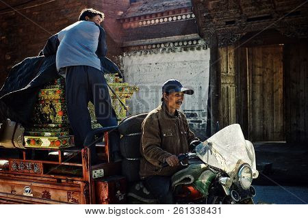 Labrang Monastery, Xiahe, Gansu Province / China - Jun 6 2011: Two Local Villager Transports A Tibet