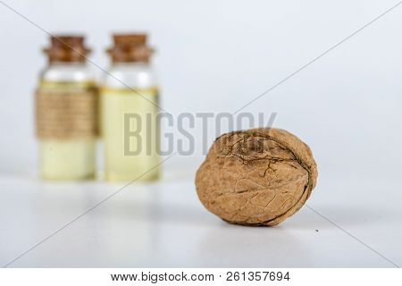 Oil In A Bottle And Walnuts On A White Kitchen Table. Spices And Ingredients Useful In Kuchi.