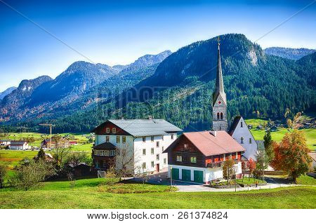 Alpine Green Fields And Traditional Wooden Houses View Of The Gosau Village At Autumn Sunny Day. Loc